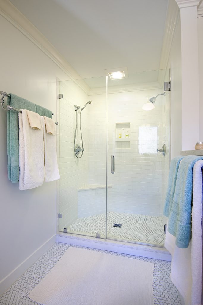 white bathroom with frameless glass shower